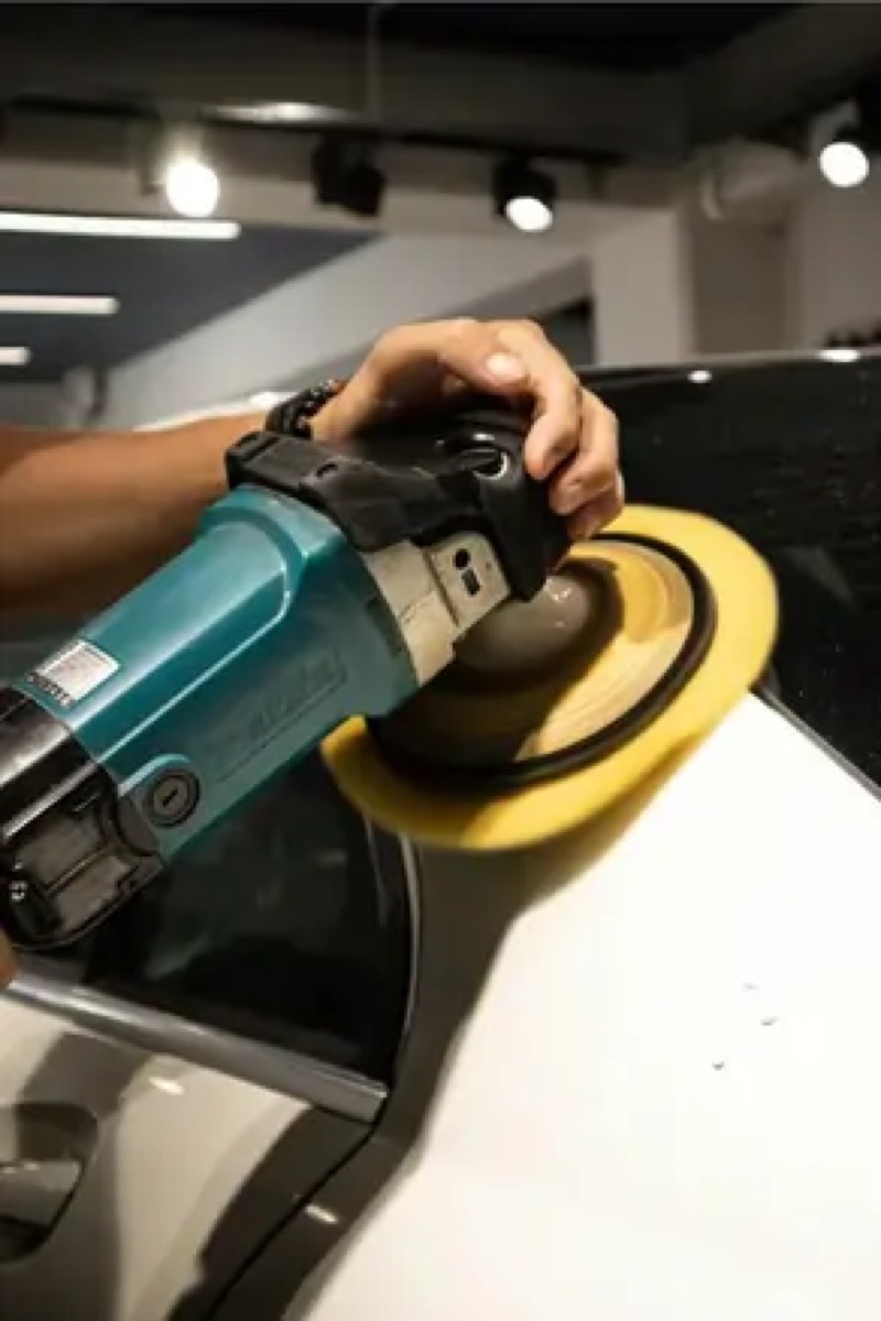 Machine polisher working on white gelcoat